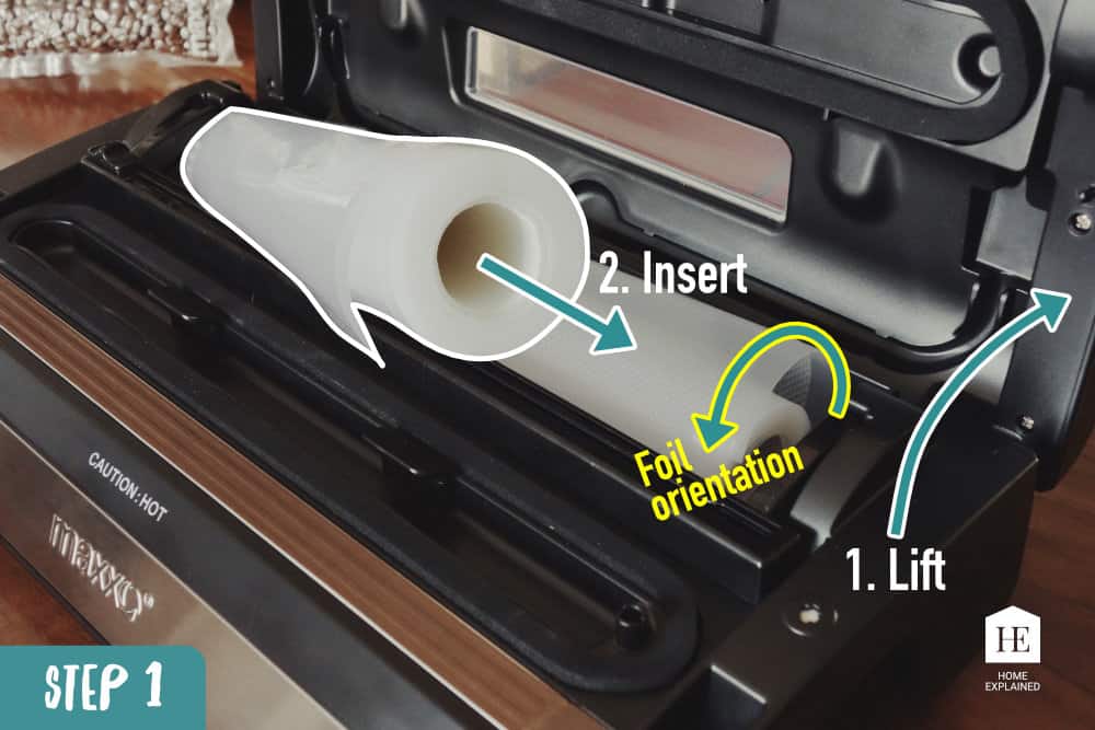 Open the vacuum sealer lid and insert the plastic roll into the back compartment