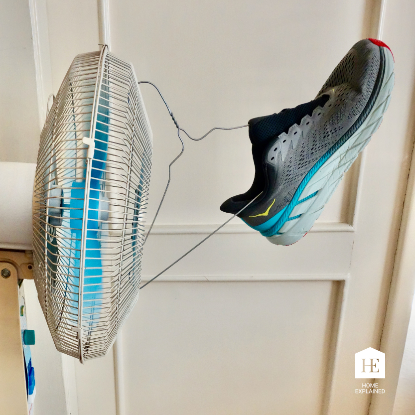 Drying shoes with a fan on a hanger